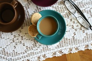 cup of coffee and biscuits on a table